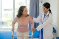 Elderly female patient with Asian female physical therapist holding her arm for physical therapy Rehabilitate weak muscles. Royalty Free Stock Photo