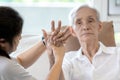 Elderly female patient suffer from numbing pain in hand,arthritis,tendon inflammation,stiffness of the joints,asian senior woman Royalty Free Stock Photo