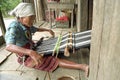 Elderly female weaver works for tourism industry