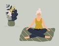 Elderly funny woman in yoga lotus position doing meditation mindfulness practice spiritual discipline at home or gym.Cute old