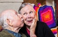 Elderly Gentleman Kissing Elderly Woman on Cheek Royalty Free Stock Photo