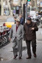 Elderly gentlemen walking in the city center. Barcelona, Spain