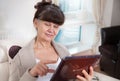 Elderly good looking woman with tablet. Portrait in domestic interior Royalty Free Stock Photo