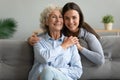 Elderly grandmother adult granddaughter posing looking at camera capture moment