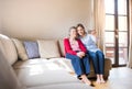 Elderly grandmother and adult granddaughter with smartphone at home. Royalty Free Stock Photo