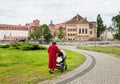 Elderly grandmother walking with baby in the stroller