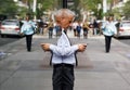 Elderly gray-haired man with a mobile phone in NYC