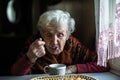 An elderly pensioner woman drinking tea at home. Royalty Free Stock Photo