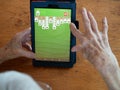 Elderly Woman`s Hands Playing Solitaire on a Tablet Royalty Free Stock Photo