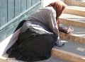 Elderly gypsy woman with headscarves on her head and long skirt