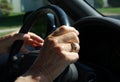 Elderly hand on steering wheel