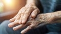 Elderly hands clasped together in detail. Close-up photography of aged skin