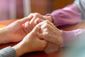 Elderly hands. Helping hands of young adult and senior women. Care and elderly concept.