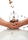 Elderly hands holding jar catching falling coins