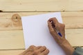 Elderly hands with paper and a pen Royalty Free Stock Photo