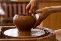 Elderly hands of a potter, creating an earthen jar on the circle. Old woman makes hand made ceramics from clay Royalty Free Stock Photo