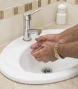 Elderly Hands Washed in Bathroom Basin. Royalty Free Stock Photo