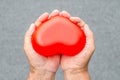 Elderly hands with wound carrying heart Royalty Free Stock Photo