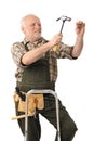 Elderly handyman hammering nail