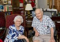 Elderly happily married couple celebrating the wife`s 87th birthday in their home. Royalty Free Stock Photo