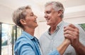 Elderly, happy and dancing couple in living room, enjoying retirement. Portrait of senior man and woman who dance Royalty Free Stock Photo