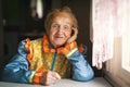 An elderly happy woman in Slavic ethnic clothing.