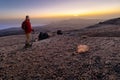 An elderly hiker with a beard stands above the clouds on Spain`s highest mountain at sunrise. Royalty Free Stock Photo