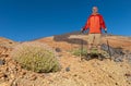 An elderly hiker with a beard stands in front of the highest mountain in Spain. Royalty Free Stock Photo