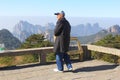 Elderly hiker enjoys the panorama in the Huangshan Yellow Mountains, China
