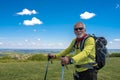 Elderly hiker male smiling after a hike on a hill