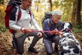 An elderly hikers couple and their dog having wonderful moments at a hike Royalty Free Stock Photo