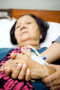 Elderly holding hands in sickness Royalty Free Stock Photo