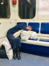 Homeless lady sleeping on a train