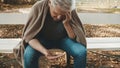 Elderly homeless man counting coins. Close up