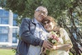 elderly husband and wife on a walk holding hands in a city park enjoying a summer day Royalty Free Stock Photo