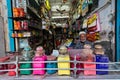 An elderly Indian shopkeeper in a paint shop