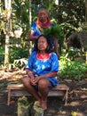 Elderly indigenous shaman of Cofan nationality performing healing ritual to a Cofan woman in the Amazon rainforest