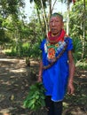 Elderly indigenous shaman of Cofan nationality walking head-on through the jungle in the Amazon