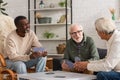 Elderly interracial friends talking while playing Royalty Free Stock Photo