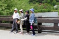 June 2018, Elderly Japanese hikers bridge river mountains Alps, Kamikochi, Japan