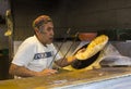An elderly Jewish male in a colourful hat making pita bread in a small home bakery near the Mahane Yehuda market in Jerusalem