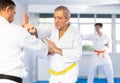 Elderly karate fighter engaging kumite with male rival Royalty Free Stock Photo