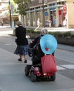 Elderly ladies walking and riding a mobility scooter in Vancouver`s downtown.