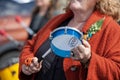 Elderly lady beating a tambourine during May Day to protest against the pension reform