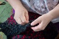 Elderly lady doing sewing hand work with needle and thread