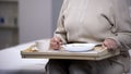 Elderly lady eating diabetic dinner in rehabilitation center, social security