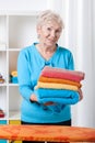 Elderly lady folding towels Royalty Free Stock Photo