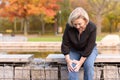 Elderly lady grabbing her knee in pain