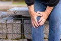 Elderly lady grabbing her knee in pain Royalty Free Stock Photo