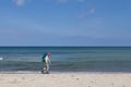 Elderly lady hiking on beach in Denmark